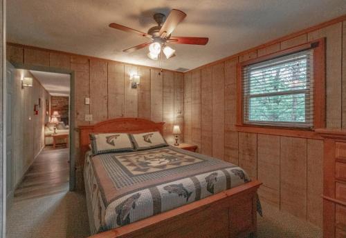 a bedroom with a bed and a ceiling fan at Swiss Mountain Village in Blowing Rock