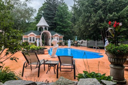a swimming pool with a statue in front of a house at The Rest in Jackson