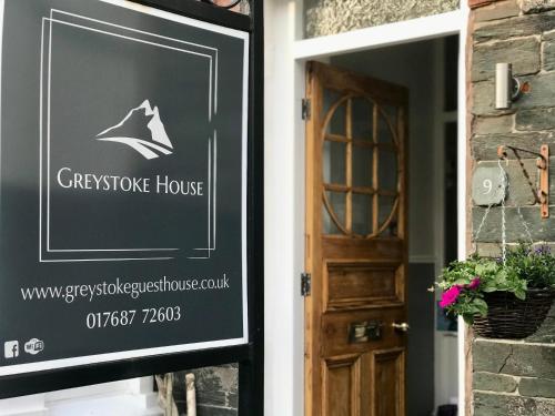 a sign for a cypresshouse house next to a door at Greystoke House in Keswick