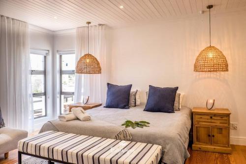 a bedroom with two beds with blue pillows at Sea La Vie in Velddrif
