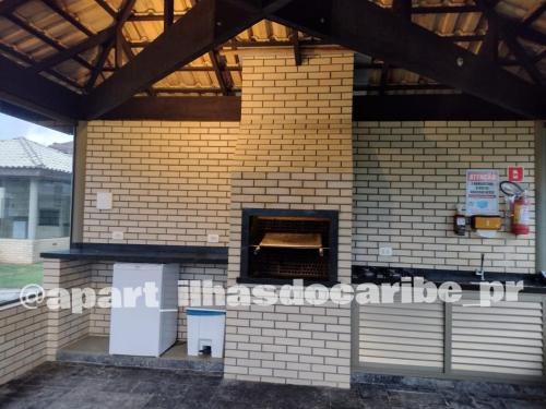 a brick building with a pizza oven on it at Apto Cond Ilhas do Caribe - Pr - Beira Mar in Matinhos