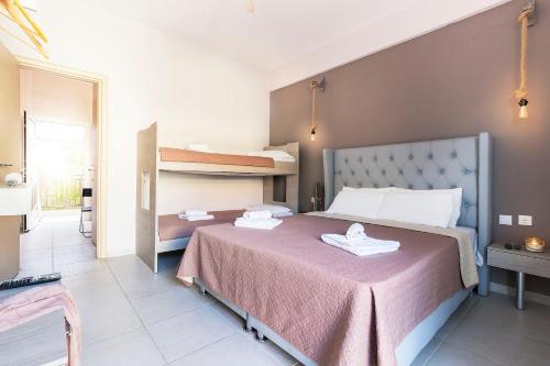 a bedroom with a large bed with two bunk beds at Sueño Luxury Apartments in Polykhrono