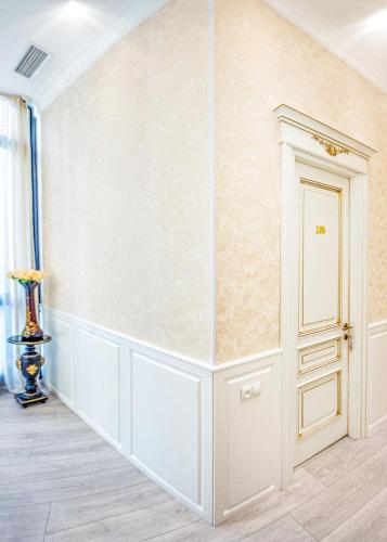a room with a white wall and a door at Vintage Hotel in Tbilisi City