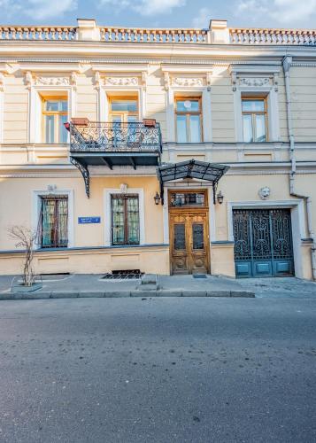 a building with a balcony on top of it at Vintage Hotel in Tbilisi City