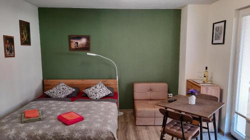 a bedroom with a bed and a table with a chair at BIKE apartments 1 in Hodruša