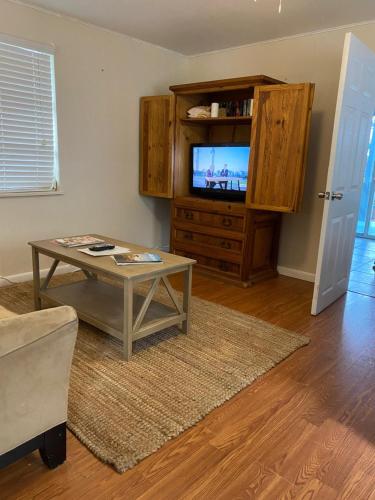 a living room filled with furniture and a tv at Turtle Beach Resort in Siesta Key