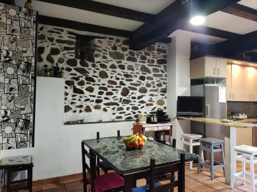 a kitchen with a table with fruit on it at Falagueira in Monforte de Lemos