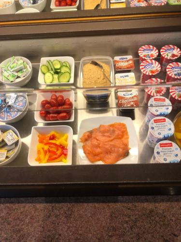 a display case filled with different types of food at Gasthof-Hotel Goldenes Schiff in Engelhartszell