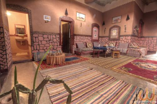 a living room with a couch and a table at Kasbah tifaoute ait Ben haddou in Aït Ben Haddou
