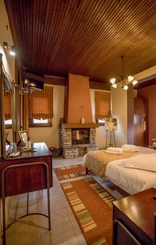 a bedroom with a bed and a fireplace at Kynthia Guesthouse in Neochori