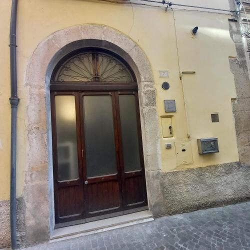 a wooden door on the side of a building at Ars Amandi in Sulmona