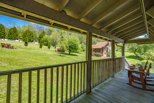 an outdoor deck with a bench and a view of a park at Swiss Mountain Village in Blowing Rock