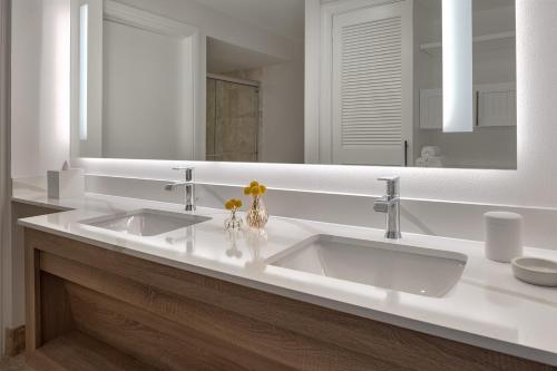 a bathroom with two sinks and a large mirror at Margaritaville Beach House Key West in Key West