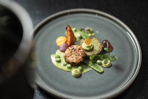 a blue plate with food on a table at SPA & Naturhotel Outside in Matrei in Osttirol