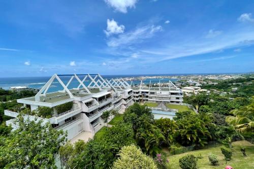 an aerial view of a building with the ocean in the background at Appartement Hana Iti breathtaking on the ocean at the entrance of Papeete in Papeete