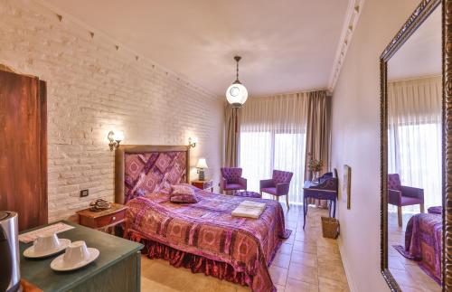 a hotel room with a bed and a mirror at Çetmihan Hotel in Kucukkuyu