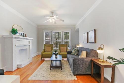 a living room with a couch and a fireplace at Stylish and Expansive 2BR Apt with Balcony - Buckingham 3 in Chicago
