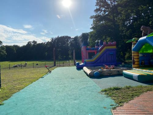 a park with a playground with a slide at Poppes Ranch Bauerhof & Campingplätze in Zepelin