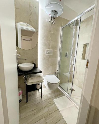 a bathroom with a toilet and a sink and a shower at Corte San Gaetano in Bari