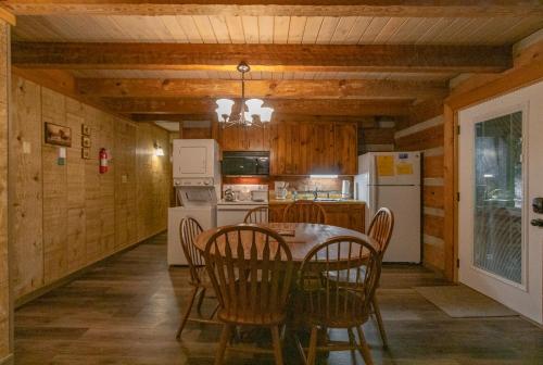 a kitchen with a table and chairs and a refrigerator at Swiss Mountain Village in Blowing Rock