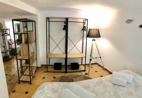a room with a bed and a tripod and a lamp at La Casita de Peñíscola - Somhome in Peñíscola