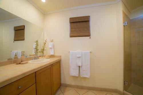 a bathroom with a sink and a shower at Los Suenos Resort Del Mar 5F golf views by Stay in CR in Herradura