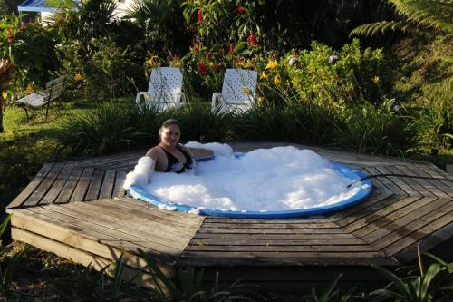 a woman in a jacuzzi tub on a deck at Ecolodge Bahia del Peñón in Guatapé