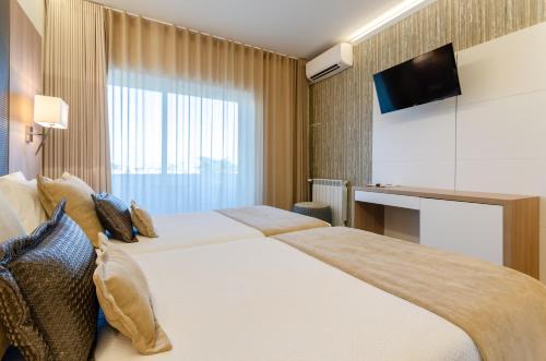 Una cama o camas en una habitación de Hotel Lido