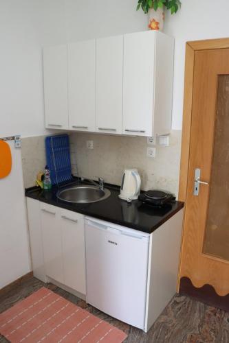 a kitchen with a sink and a counter top at Rooms & Apartment Jozić in Prozor