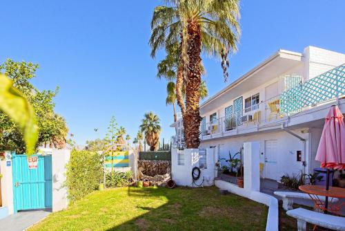 a house with a palm tree in the yard at Inn at Palm Springs in Palm Springs