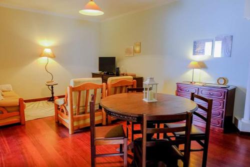 a living room with a dining room table and chairs at Granny's house view in Funchal