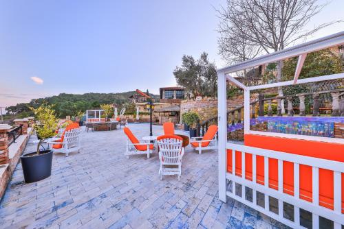 a group of chairs and tables on a patio at Çetmihan Hotel in Kucukkuyu