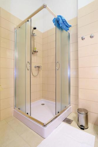 a shower with a glass enclosure in a bathroom at Apartments Dado Trogir in Trogir