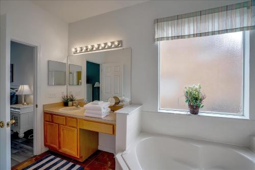 a bathroom with a sink and a mirror at SOLANA 7 Bed Rooms FAMILY VACATION VILLA-Private Pool and SPA in Davenport