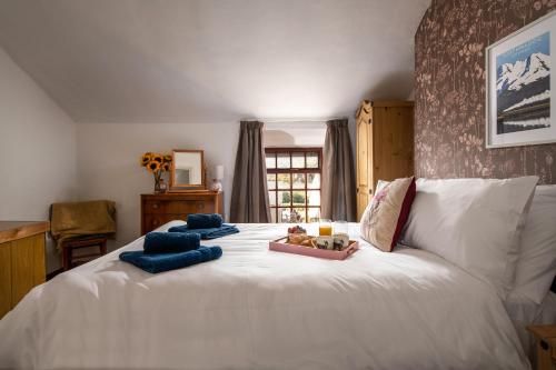 a bedroom with a white bed with blue towels on it at Homely cottage with garden and mountain-view in Blaenau-Ffestiniog