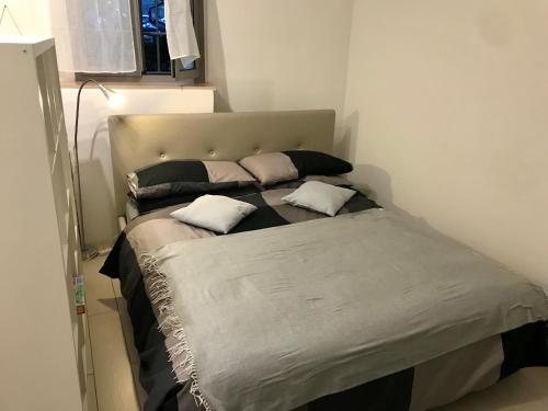a bed with two pillows on it in a room at Navona Dream Home in Rome