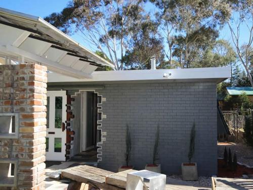 a brick fireplace in front of a house at Up cycle House Blackheath in Blackheath