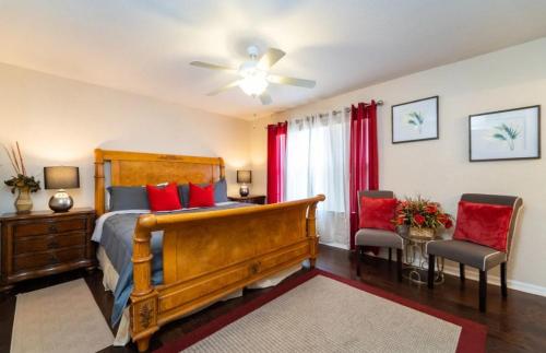 a bedroom with a bed with red pillows at Relaxing resort, spacious pool near Disney in Davenport