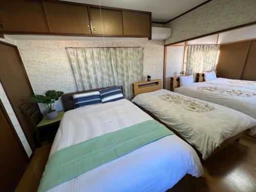 Ένα ή περισσότερα κρεβάτια σε δωμάτιο στο 別府ホーム
