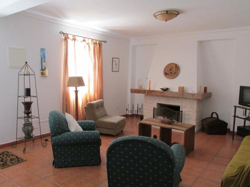 a living room with chairs and a fireplace at Casal Alentejano in Sintra