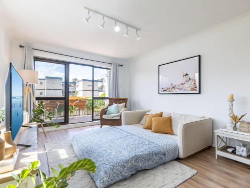 a white living room with a bed and a window at Bahia 1 Newly renovated unit with Filtered Water Views in Shoal Bay