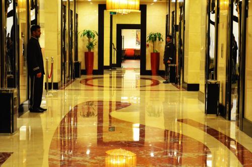 two men standing in a hallway in a building at Al Ghufran Safwah Hotel Makkah in Makkah