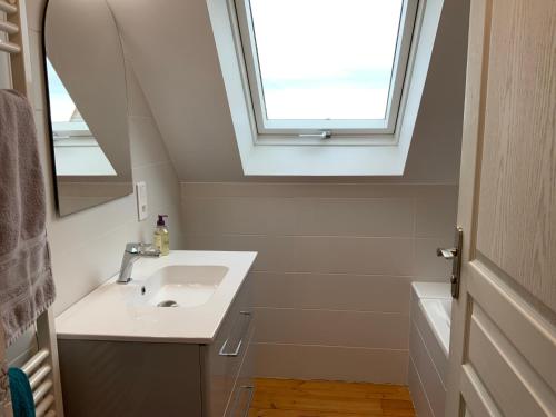 łazienka z umywalką i oknem w obiekcie Maison TY Traon - w mieście Audierne