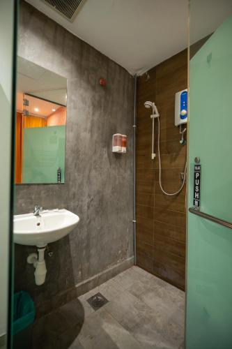 a bathroom with a sink and a shower at Apollo Inn in George Town