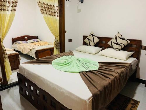 Ένα ή περισσότερα κρεβάτια σε δωμάτιο στο Ella Sandy Heaven Homestay