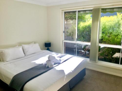 Postel nebo postele na pokoji v ubytování Wagga Apartments #7