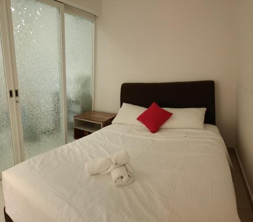 a white bed with a stuffed animal on it at (Cutiepie)Duplex condo@Maritime 8 in George Town