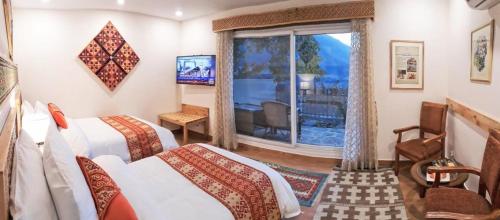 a hotel room with two beds and a window at SERENA ALTIT FORT RESIDENCE in Hunza