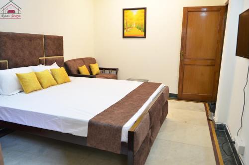a bedroom with a large bed with yellow pillows at Furnished 2BHK Independent Apartment 8 in Greater Kailash - 1 with 2 Balconies in New Delhi