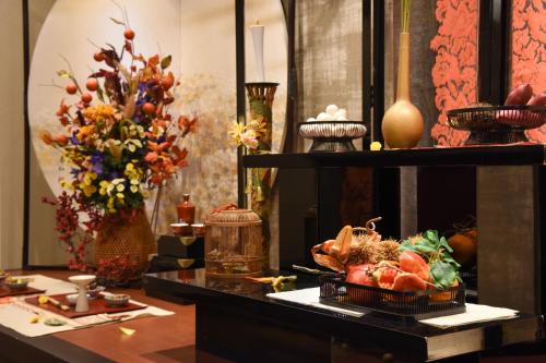 a table with a bunch of flowers on it at Arima Onsen Koki in Kobe